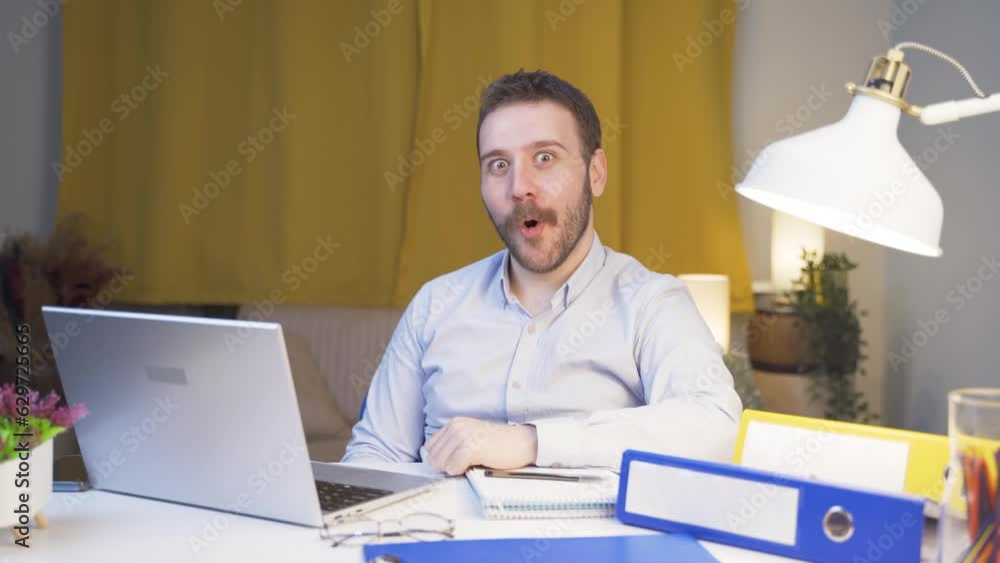 Home office worker man says wow to camera. Home office worker man says wow to camera.