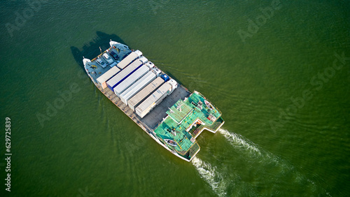 Aerial view of a ferry boat transport trucks, cars and people