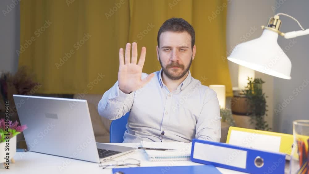 Home office worker man says stop to camera, warns. Home office worker man says stop to camera, warns.