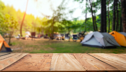 Wooden table background of free space for your decoration and blurred background of camping in mountains.