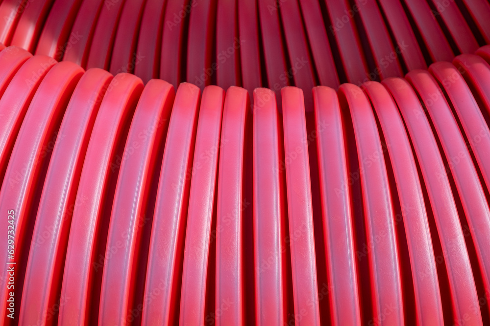 red corrugated PVC pipe cover protection for electric cables.  macro filled frame. Construction site with Material infrastructure installation.