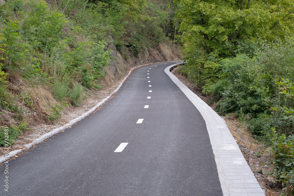 New asphalt on the road surface. Shared bike lanes in Europe. Public park