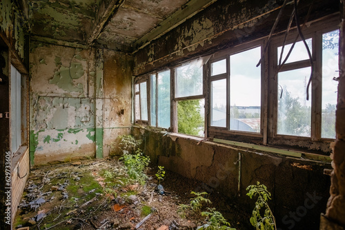 Tableau sur toile Overgrown by plants old abandoned building interior