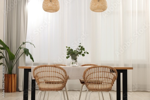 Fototapeta Naklejka Na Ścianę i Meble -  Stylish dining room with cozy furniture and plants
