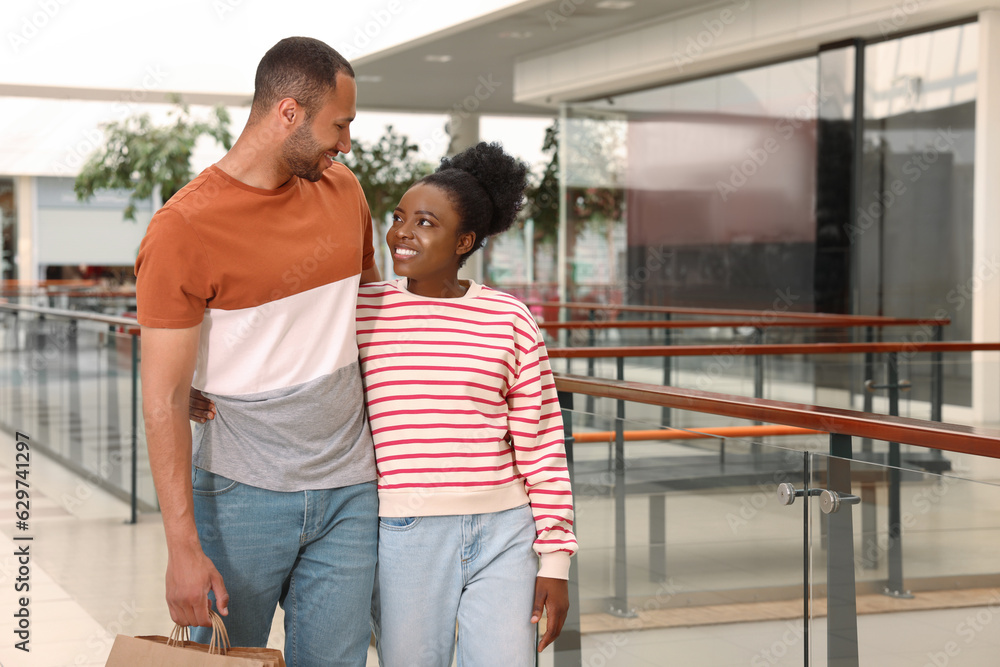 Family shopping. Happy couple with purchases in mall Family shopping. Happy couple with purchases in mall