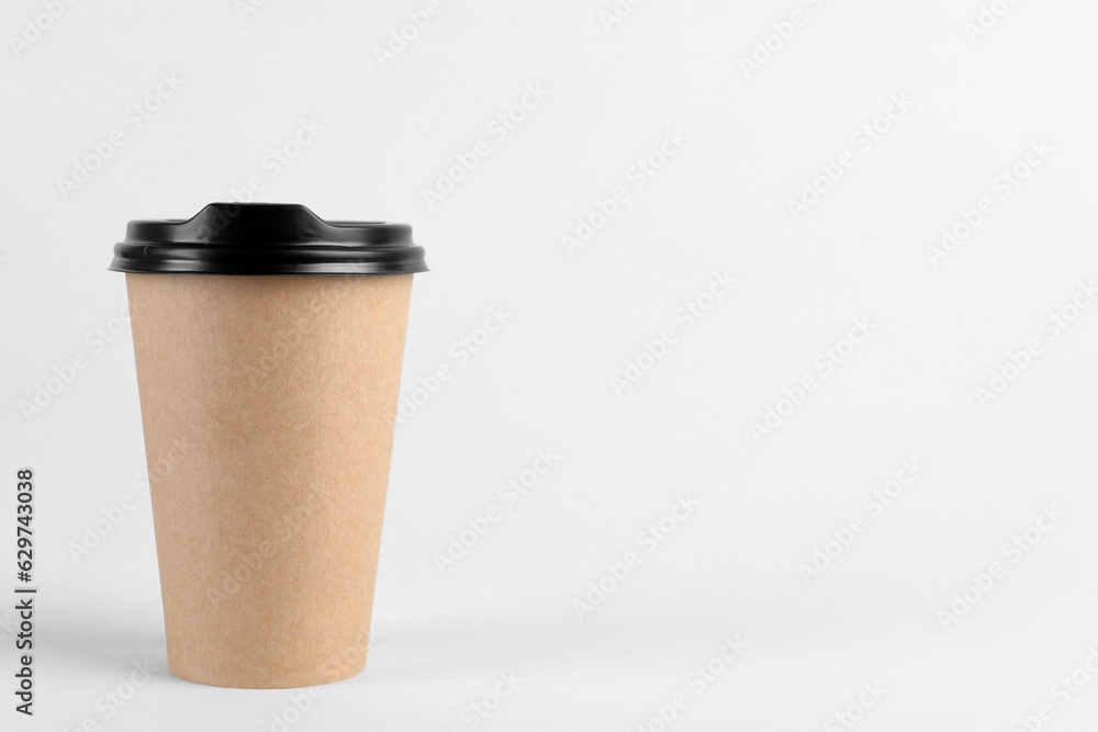 Paper cup with plastic lid on light background, space for text. Coffee to go Paper cup with plastic lid on light background, space for text. Coffee to go