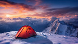 Orange tent in winter mountains skies standing in snow with a majestic view of a slope for skiing in mountains.
