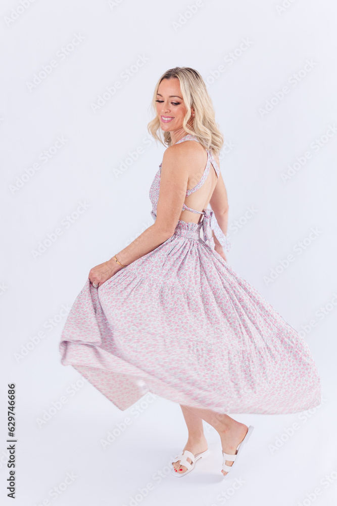 Blonde woman in purple spring dress against white background Blonde woman in purple spring dress against white background