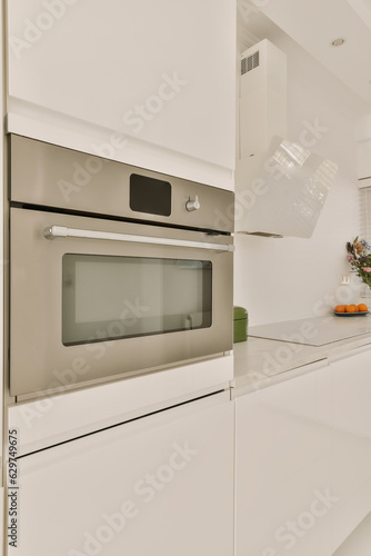 a kitchen with white cabinets and an oven on the counter top in front of the microwave is open to show how it's working