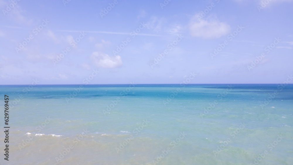 blue beach and clouds reflection on the sea surface, natural colors, blue background aerial view.insert text
