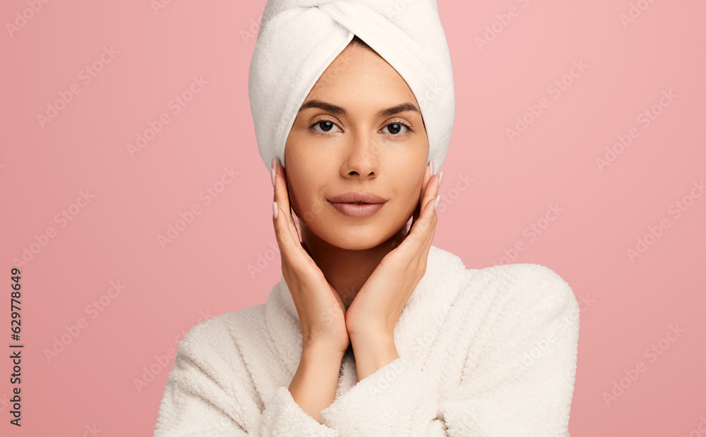 Charming woman in bathrobe looking at camera in studio Charming woman in bathrobe looking at camera in studio