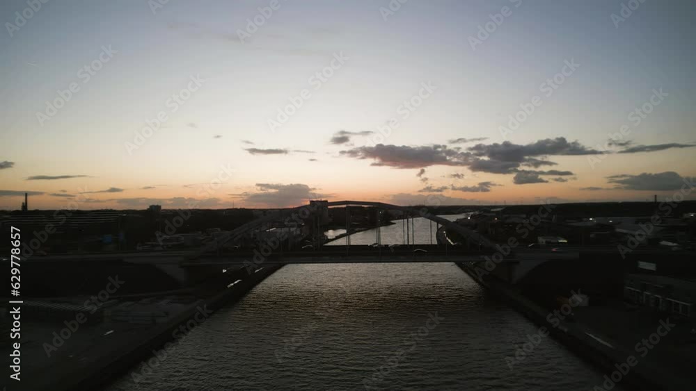 Silhouette of city and bridge during sunset, aerial drone view Silhouette of city and bridge during sunset, aerial drone view