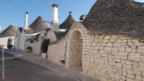Alberobello Italy - traditional trulli houses with conical stone roofs. Famous landmark, travel destination and tourist attraction near Bari in Puglia, Europe. Street with ancient architecture.