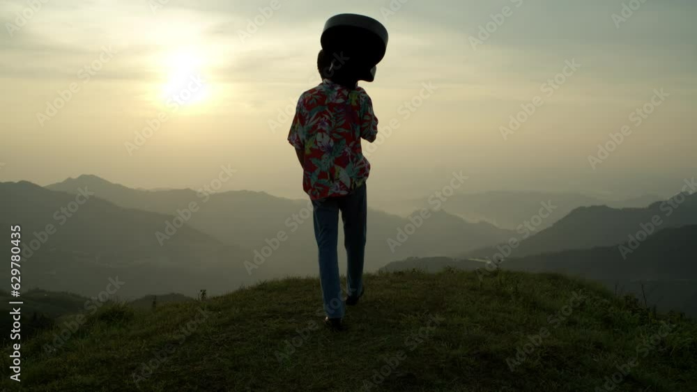 Male Musician Walks With Guitar at the Edge of the Mountain Watching the Sunset, Relaxing Landscape Atmosphere wearing Vintage Jeans and Shirt Male Musician Walks With Guitar at the Edge of the Mountain Watching the Sunset, Relaxing Landscape Atmosphere wearing Vintage Jeans and Shirt