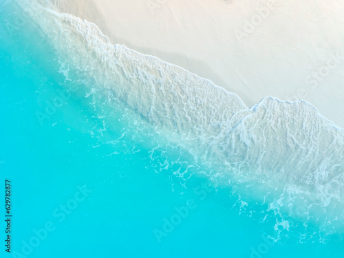 Beach Wave water in the Tropical summer beach with white sand beach background