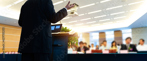 Business man making a speech in front of big audience photo