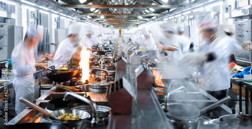 Motion chefs working in Chinese restaurant kitchen