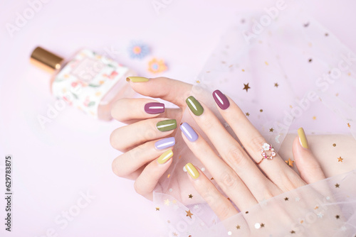 Beautiful colored nail polishes with shine and reflections Fashionable spring summer nail design large aperture blurred background