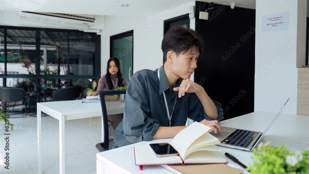 Tired stressed office worker sitting at desk and thinking, he is rubbing his eyes and feeling exhausted Tired stressed office worker sitting at desk and thinking, he is rubbing his eyes and feeling exhausted