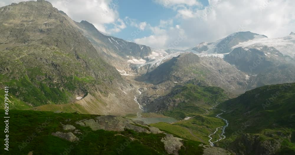 Aerial drone view of Susten mountain pass in Switzerland with lake and mountains in background Aerial drone view of Susten mountain pass in Switzerland with lake and mountains in background