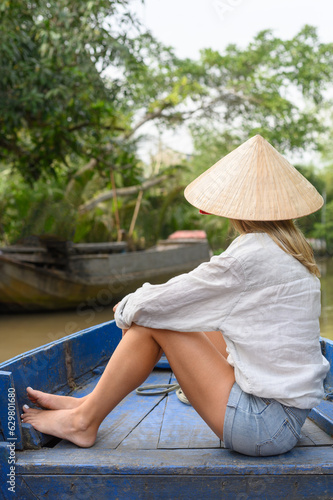Female tourist on boat in Mekong River Delta, Vietnam © Franci Leoncio
