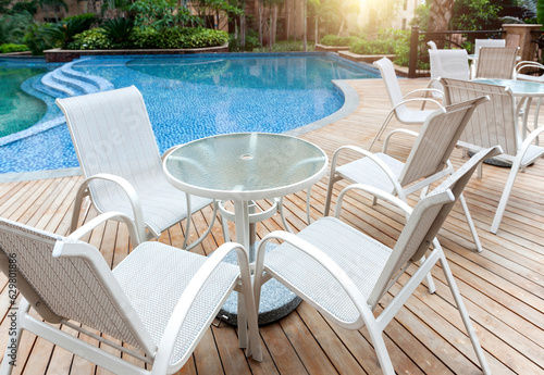 Chairs and tables next to swimming pool