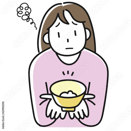 ダイエットのためにご飯を減らして不満顔の若い女性