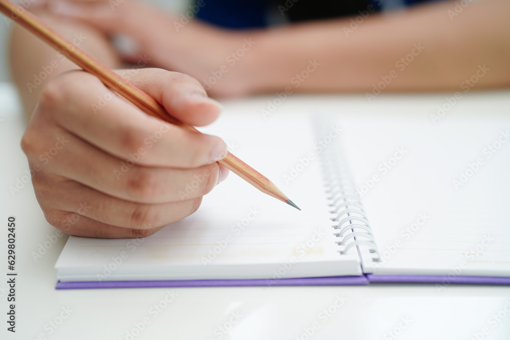 Asian teenage student write homework, study lesson for exam online learning education. Asian teenage student write homework, study lesson for exam online learning education.