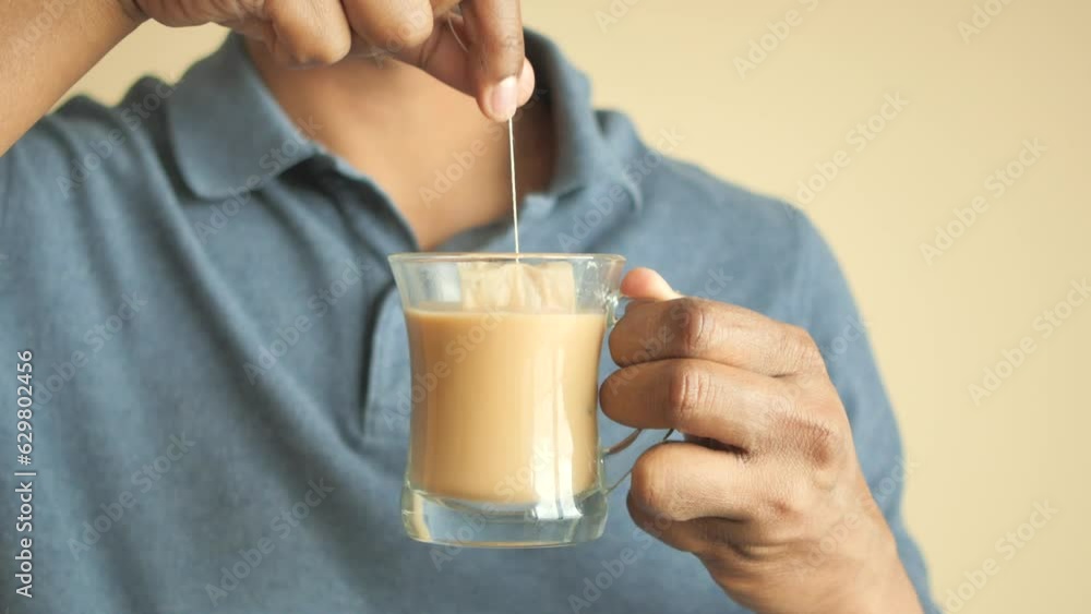 Tea bag in a white cup of tea. Making morning tea. 