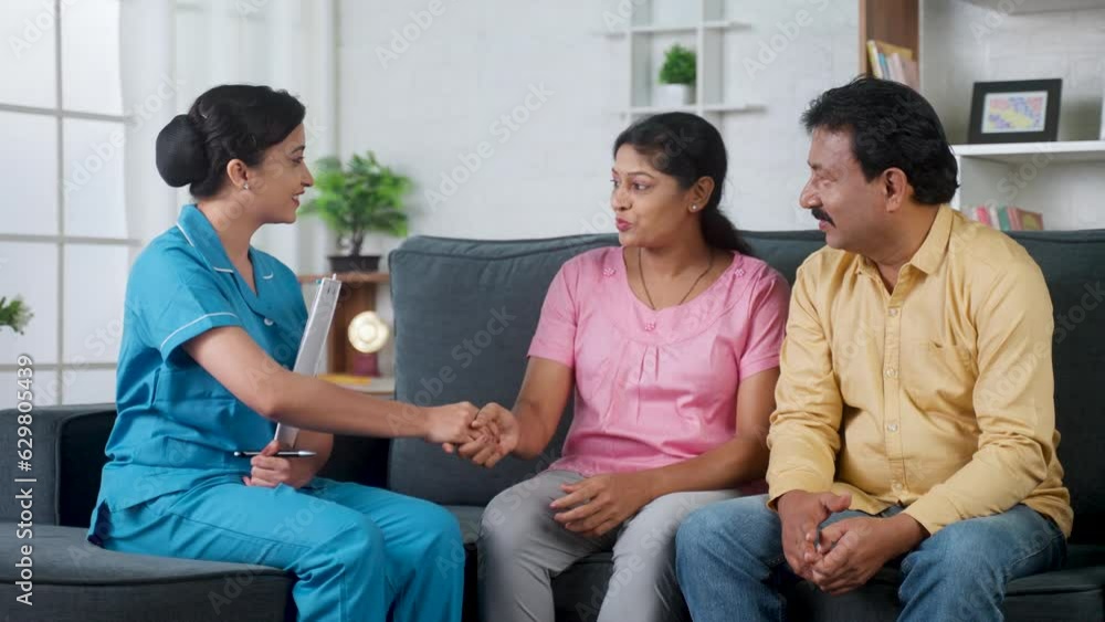 Happy indian nurse greeting by shaking hands with couple during home visit at home - concept of medical support, Homecare Service and Health Assessment. Happy indian nurse greeting by shaking hands with couple during home visit at home - concept of medical support, Homecare Service and Health Assessment.
