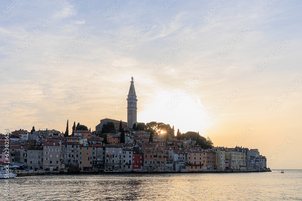 Tower of St. Euphemia Church in Rovinj on the peninsula with the picturesque old town in the light of the sunset
