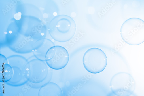 Refreshing of Soap Suds  Bubbles Water. Beautiful Transparent Blue Soap Bubbles Floating in The Air. Abstract Background  Blue Gradient Blurred Textured.