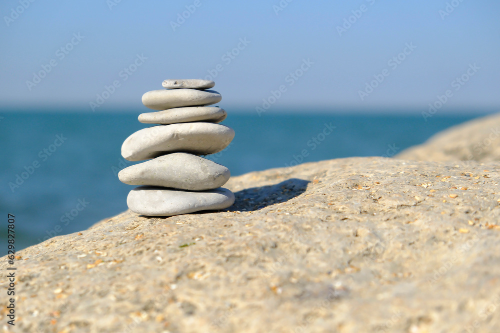 Pebble tower balance harmony stones arrangment on sea beach coastline. Spa therapy summer travel vacation. Pebble tower balance harmony stones arrangment on sea beach coastline. Spa therapy summer travel vacation.