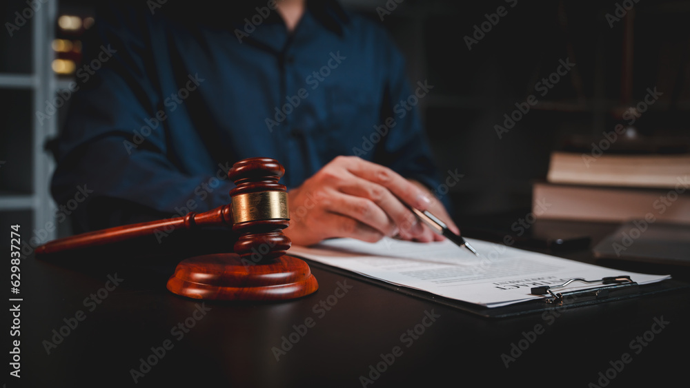 concept of justice and law A male judge in the courtroom on a wooden table and a male counselor or lawyer working in the office. Law, advice and justice concepts. concept of justice and law A male judge in the courtroom on a wooden table and a male counselor or lawyer working in the office. Law, advice and justice concepts.