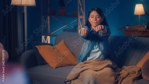Female sleepwalker sits on a sofa in the living room close up. Somnambulism. photo