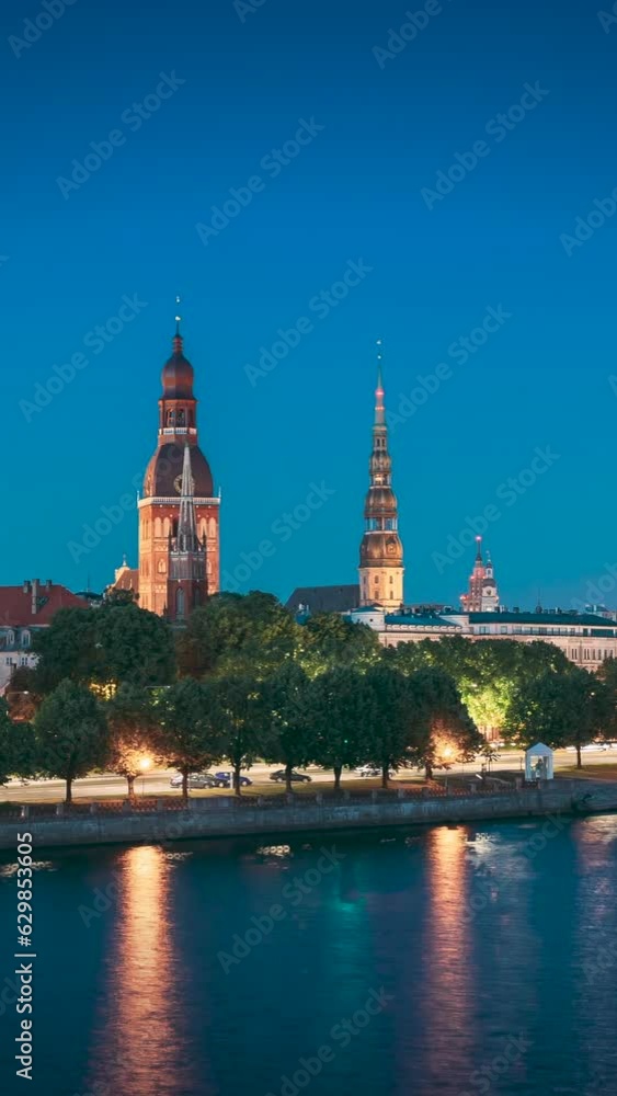 Riga, Latvia, Europe. Hyperlapse Cityscape Skyline In Evening Time. Night View Of Castle, Dome Cathedral And St. Peter's Church. Vertical Footage Video Of Popular Place. Unesco World Heritage Site. Riga, Latvia, Europe. Hyperlapse Cityscape Skyline In Evening Time. Night View Of Castle, Dome Cathedral And St. Peter's Church. Vertical Footage Video Of Popular Place. Unesco World Heritage Site.