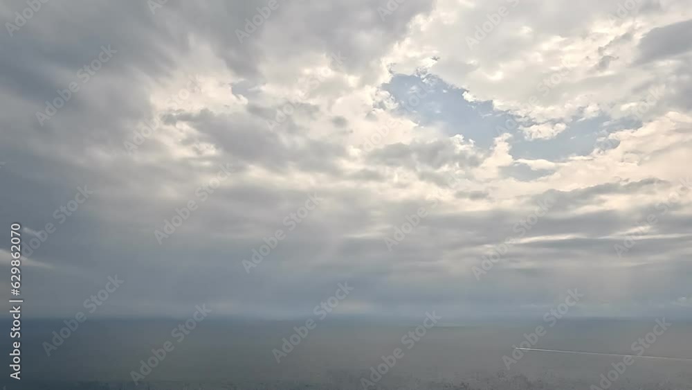Timelapse of rainy clouds moving in grey sky over sea. Abstract aerial nature summer ocean sunset sea and sky background. Vacation, travel and holiday concept. Weather and Climate Change Timelapse of rainy clouds moving in grey sky over sea. Abstract aerial nature summer ocean sunset sea and sky background. Vacation, travel and holiday concept. Weather and Climate Change
