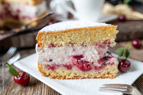 Cherry cream Cake on wooden background. close-up with selective focus 