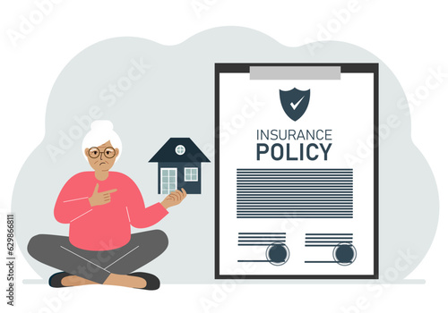 A woman holds in his hands at home next to a large insurance contract. Home and real estate insurance concept.