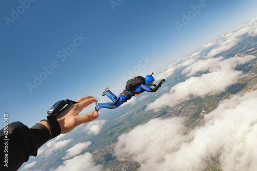A hand catching skydiver in the air photo