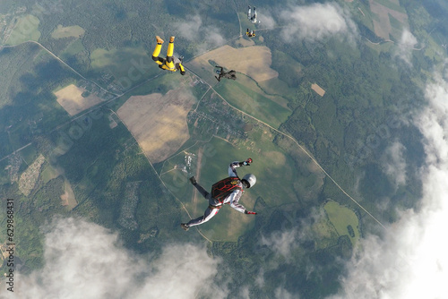Foto Group of skydivers in the air over the land