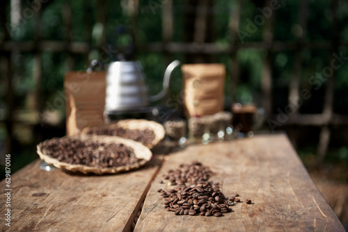 Rosted Arabica Coffee Bean on the Table with Natural organic farm Background photo