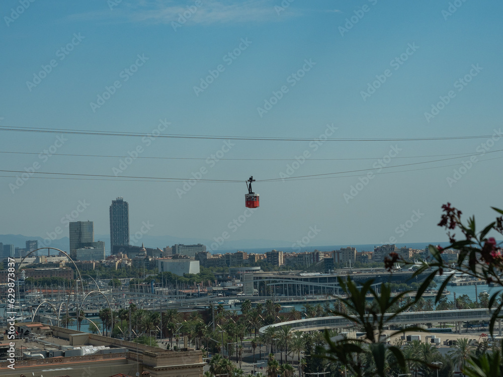 red cable car over barcelona, ​​view of the city from above