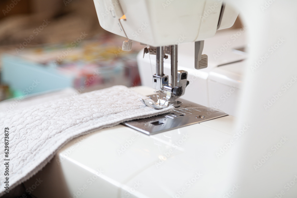 Modern sewing machine makes seam on light fabric..