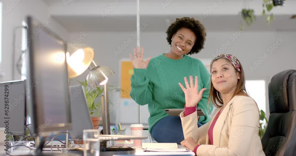 Portrait of happy diverse business female colleagues waving in casual office meeting, slow motion Portrait of happy diverse business female colleagues waving in casual office meeting, slow motion