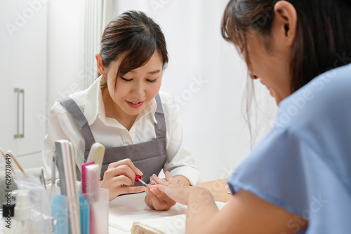 顧客に施術をするネイリスト