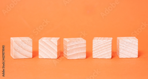 Five empty wooden cubes with place for letters