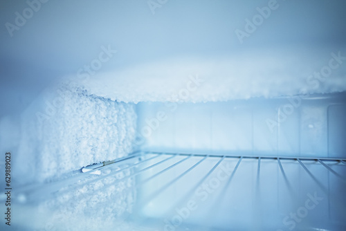 Empty open freezer in the refrigerator. photo