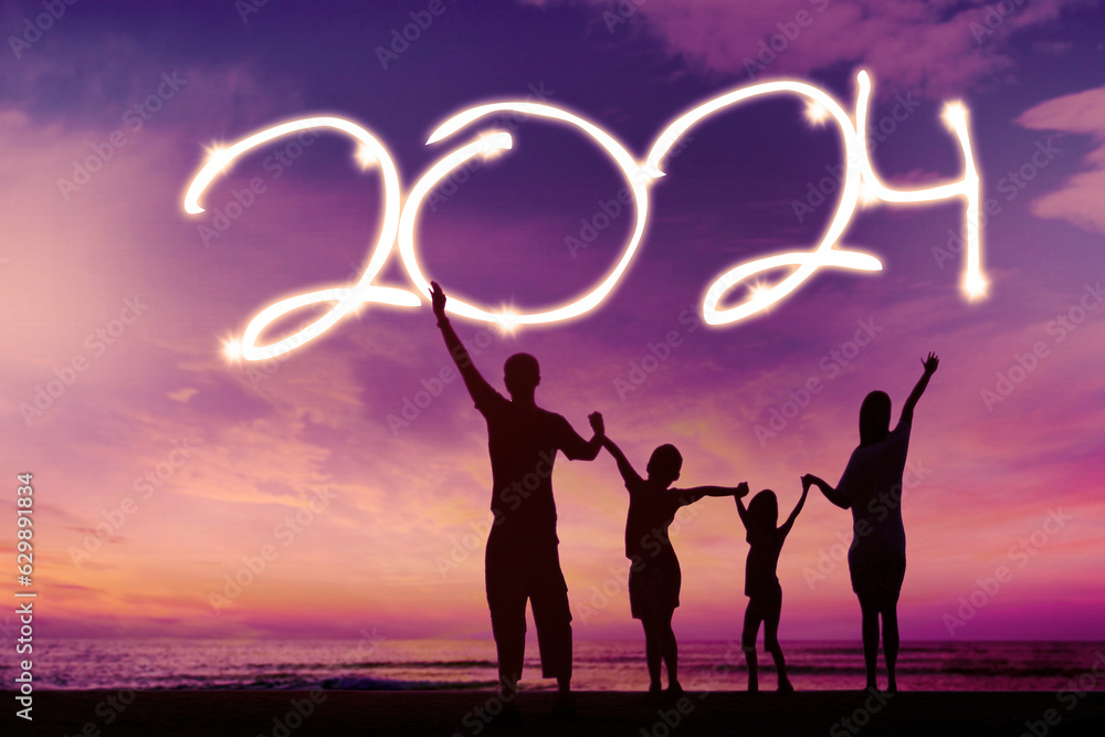 Silhouette of happy family playing on beach and enjoy new year holiday of 2024 Silhouette of happy family playing on beach and enjoy new year holiday of 2024