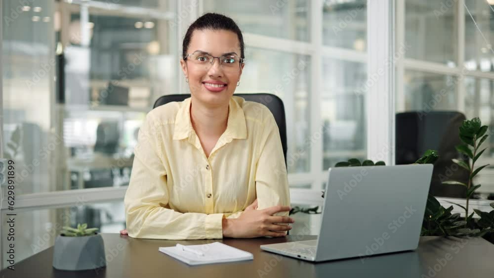 Charming african american woman, office worker manager, wearing a yellow shirt, takes off her glasses looks confidently with a healthy beautiful smile at the camera. Girl has confident radiant smile. Charming african american woman, office worker manager, wearing a yellow shirt, takes off her glasses looks confidently with a healthy beautiful smile at the camera. Girl has confident radiant smile.